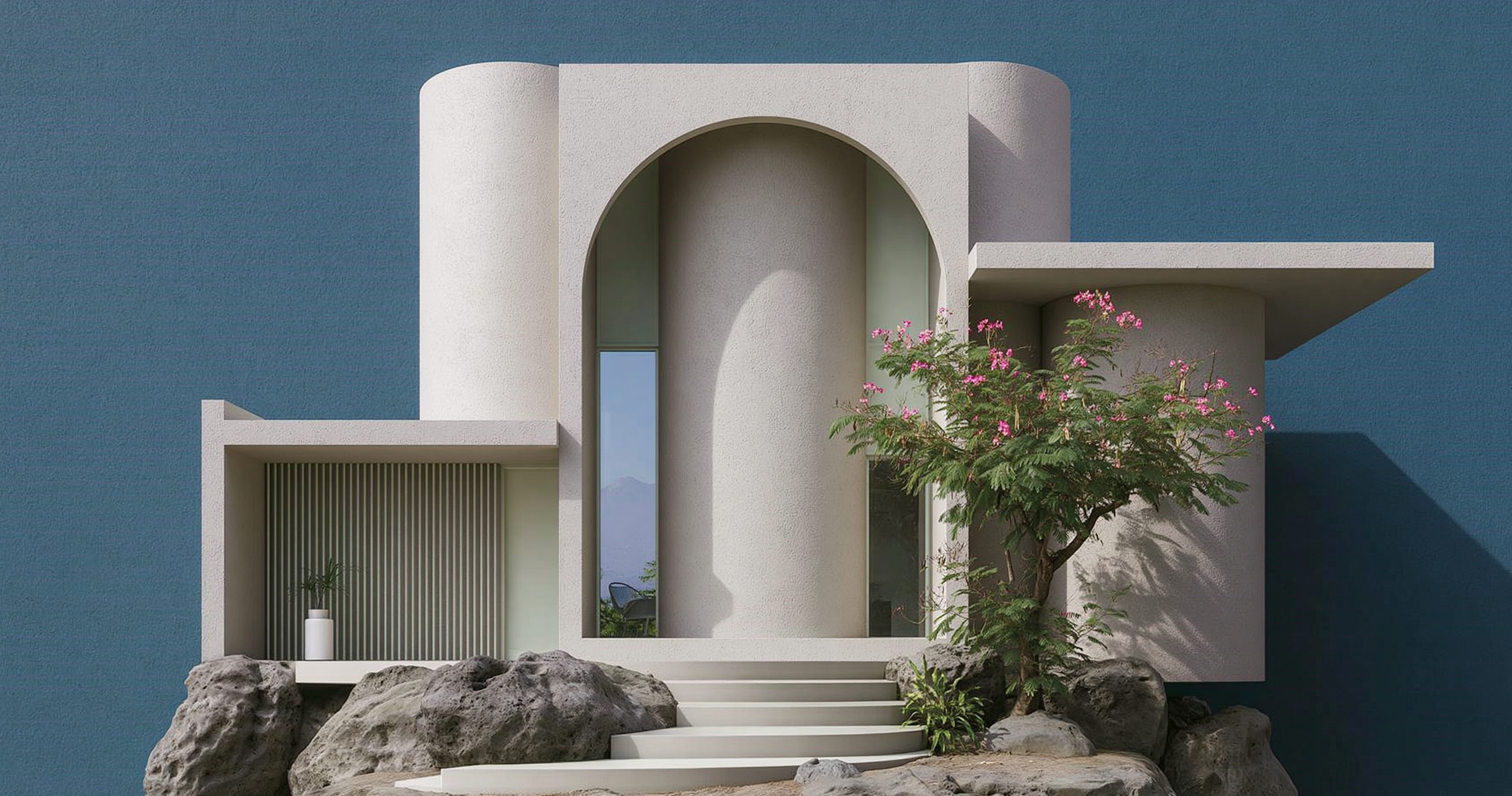 White geometric house with a large central arch, deep blue walls, flowering trees, and stone landscaping